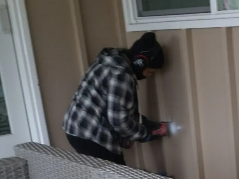 Professional electrician installing an exterior outlet in Benson