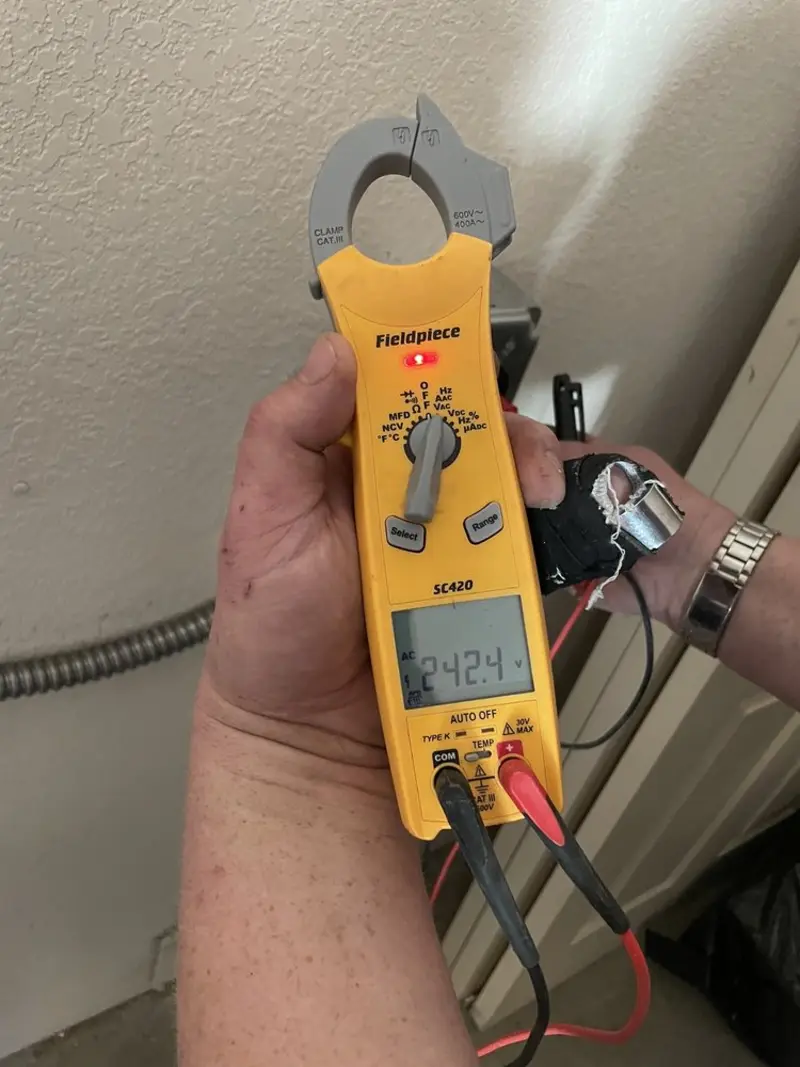 Voltage testing with clamp meter during Whole House Surge Protector in Benson